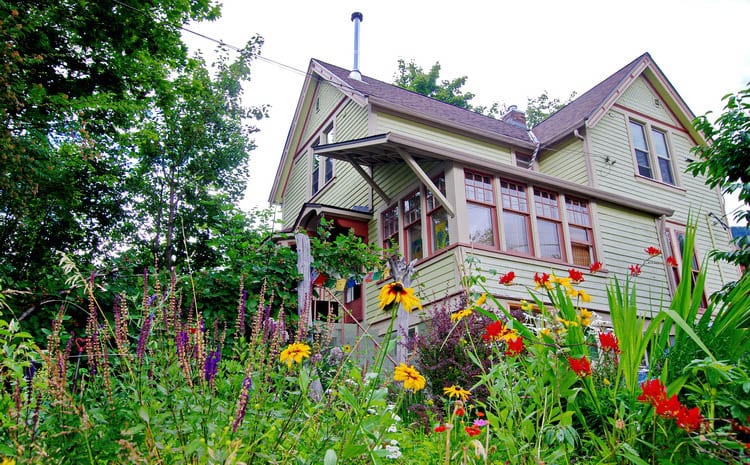 A heritage home in Nelson, BC with flowers in the foreground