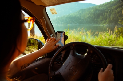 A girl using the Kootenay Lake Road Trip App 